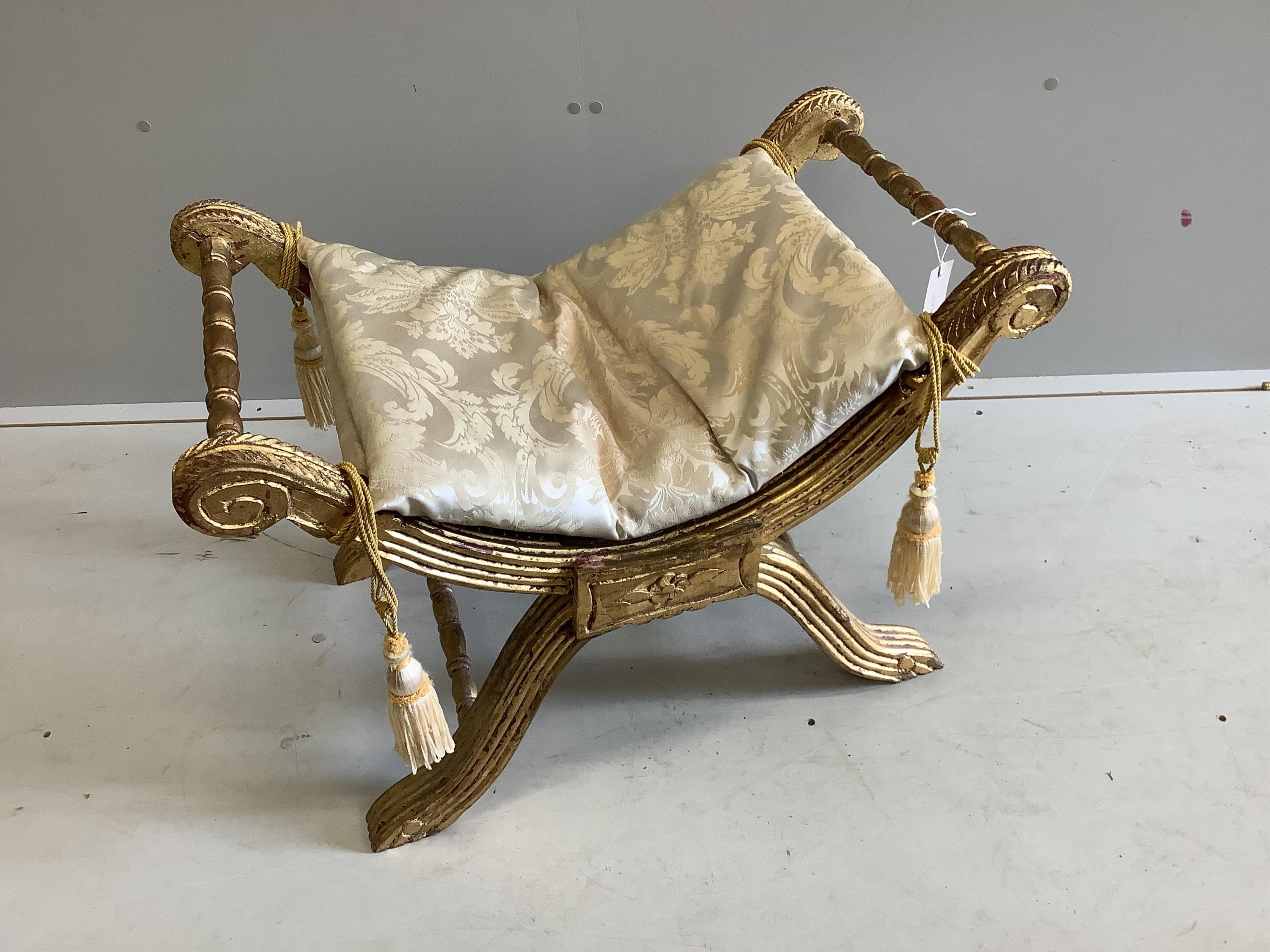 An 18th century style giltwood X frame dressing stool, width 76cm, depth 46cm, height 53cm. Condition - fair